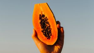 Preview wallpaper papaya, fruit, exotic, hand