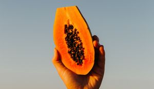 Preview wallpaper papaya, fruit, exotic, hand