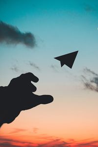 Preview wallpaper paper airplane, hand, sky, sunset