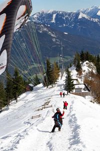 Preview wallpaper parachute, landing, extreme, snow, mountains, road