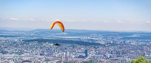 Preview wallpaper paraglider, city, buildings, flight, trees