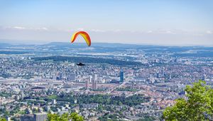 Preview wallpaper paraglider, city, buildings, flight, trees