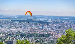 Preview wallpaper paraglider, city, buildings, flight, trees