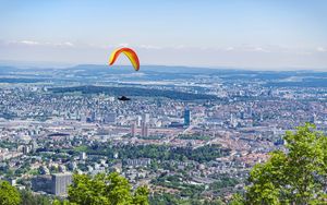 Preview wallpaper paraglider, city, buildings, flight, trees
