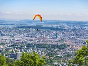 Preview wallpaper paraglider, city, buildings, flight, trees