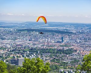 Preview wallpaper paraglider, city, buildings, flight, trees