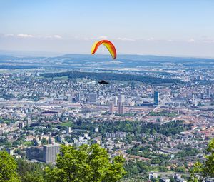 Preview wallpaper paraglider, city, buildings, flight, trees