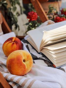 Preview wallpaper peach, fruit, book, page, cloth