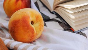 Preview wallpaper peach, fruit, book, page, cloth