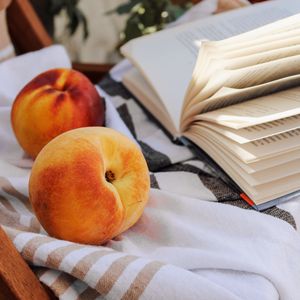 Preview wallpaper peach, fruit, book, page, cloth