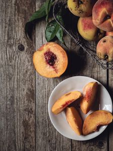 Preview wallpaper peach, fruit, wooden, plate