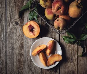 Preview wallpaper peach, fruit, wooden, plate