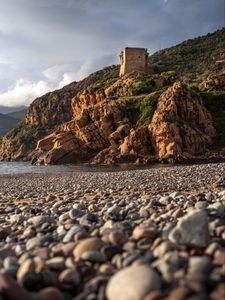 Preview wallpaper pebbles, rocks, sea, coast, building, nature