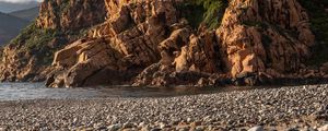 Preview wallpaper pebbles, rocks, sea, coast, building, nature