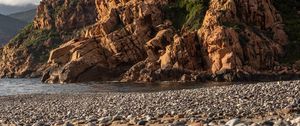 Preview wallpaper pebbles, rocks, sea, coast, building, nature