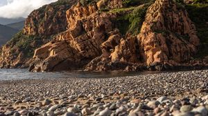 Preview wallpaper pebbles, rocks, sea, coast, building, nature