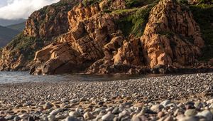 Preview wallpaper pebbles, rocks, sea, coast, building, nature