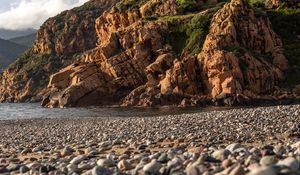 Preview wallpaper pebbles, rocks, sea, coast, building, nature