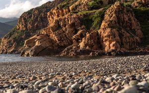 Preview wallpaper pebbles, rocks, sea, coast, building, nature