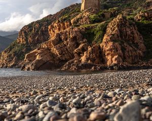 Preview wallpaper pebbles, rocks, sea, coast, building, nature