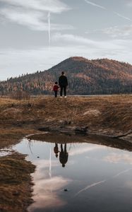 Preview wallpaper people, hill, forest, landscape, puddle, reflection