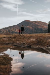 Preview wallpaper people, hill, forest, landscape, puddle, reflection