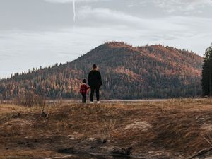 Preview wallpaper people, hill, forest, landscape, puddle, reflection