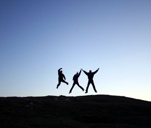 Preview wallpaper people, jump, hill, shadow, silhouette