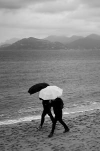 Preview wallpaper people, umbrellas, rain, sea, beach