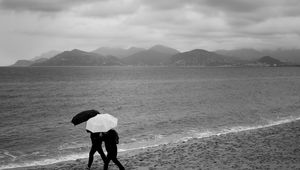 Preview wallpaper people, umbrellas, rain, sea, beach