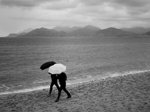 Preview wallpaper people, umbrellas, rain, sea, beach