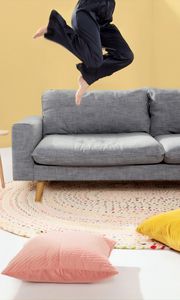 Preview wallpaper person, jump, sofa, pillows