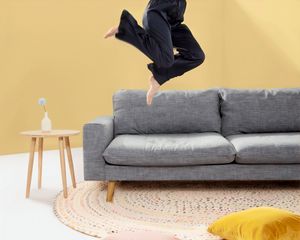 Preview wallpaper person, jump, sofa, pillows
