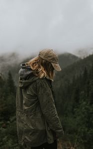 Preview wallpaper person, silhouette, mountains, forest, rain