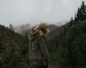 Preview wallpaper person, silhouette, mountains, forest, rain