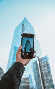 Preview wallpaper phone, camera, hand, building, city