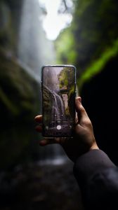 Preview wallpaper phone, camera, hand, waterfall