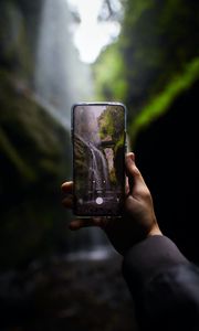 Preview wallpaper phone, camera, hand, waterfall