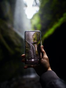 Preview wallpaper phone, camera, hand, waterfall