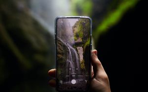 Preview wallpaper phone, camera, hand, waterfall