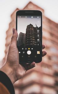 Preview wallpaper phone, hand, building, photo