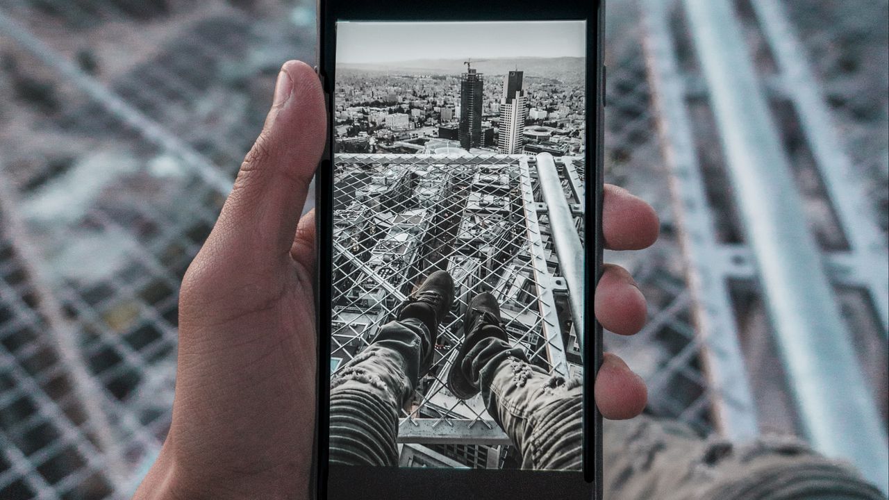 Wallpaper phone, hand, photo, roof, city, aerial view