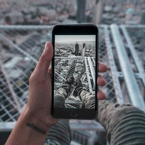 Preview wallpaper phone, hand, photo, roof, city, aerial view