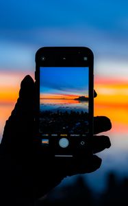 Preview wallpaper phone, hand, photo, sunset, dark