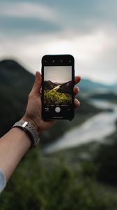 Preview wallpaper phone, hand, river, nature