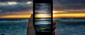 Preview wallpaper phone, hand, shooting, sunset, sea