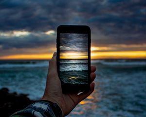 Preview wallpaper phone, hand, shooting, sunset, sea