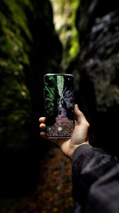 Preview wallpaper phone, hand, shooting, rocks, cave