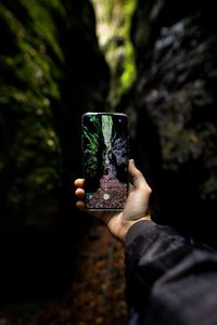 Preview wallpaper phone, hand, shooting, rocks, cave
