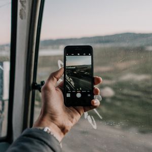 Preview wallpaper phone, hand, window, photo, focus